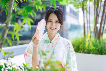浴衣を着て街を歩く若い女性