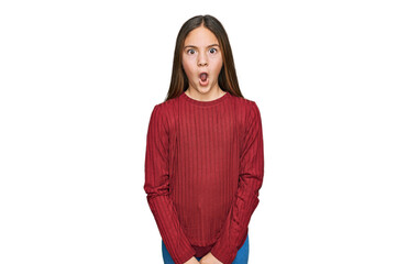 Beautiful brunette little girl wearing casual sweater afraid and shocked with surprise expression,...