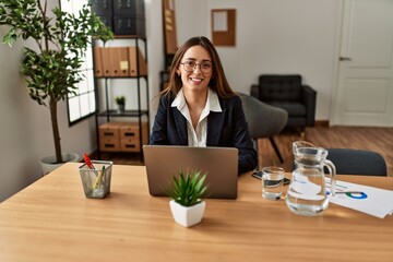 Young hispanic woman business worker using laptop working at office