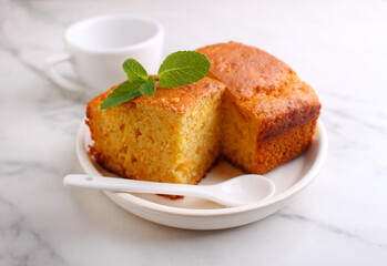 Semolina cake with pumpkin cut into pieces and garnished with mint