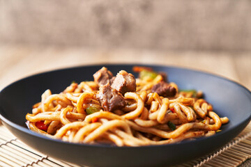  Plate of noodles on a wooden surface
