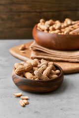 Image of bunch of peanuts in a bowl on a concrete surface