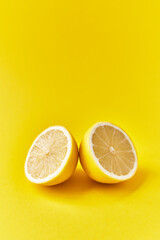  Two lemon halves fruit on a yellow background