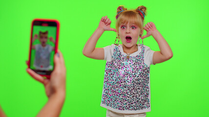 Dancing young little kid girl blogger record dance moves at camera for social media content using...