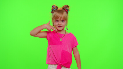 Joyful little Caucasian kid girl blogger front of phone camera record video enjoy dance content on green chroma key background. Social distance coronavirus pandemic concept. Freedom active lifestyle