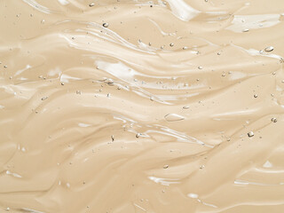 Liquid gel cosmetic texture on beige nude background. Aesthetic beautiful textured smears...