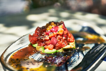Beautiful delicious salmon tartar with avocado and strawberry image