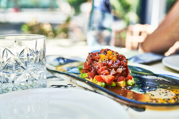 Beautiful delicious salmon tartar with avocado and strawberry image