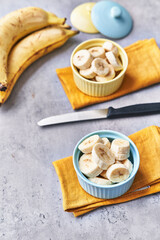  Bowls of slices of banana on a concrete surface