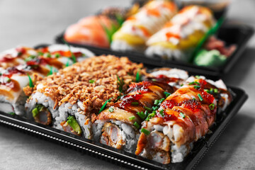  Delivery tray of uramaki sushi on a concrete surface