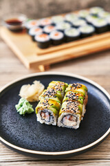 Plate of shrimp and cheese cream uramaki sushi on a wooden surface