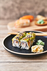  Plate of shrimp and cheese cream uramaki sushi on a wooden surface