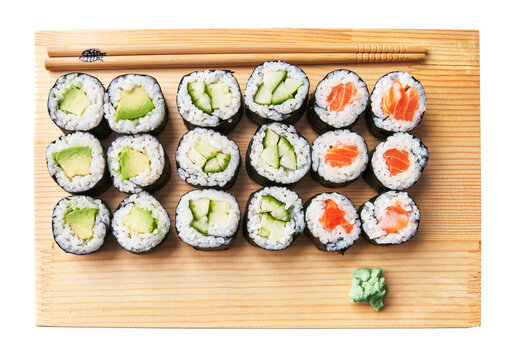  Wooden board with avocado, salmon and cucumber sushi makis isolated on white background