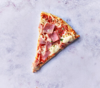  Slice of prosciutto italian pizza on a marble surface