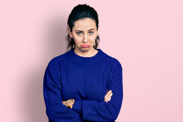 Young hispanic woman with arms crossed gesture depressed and worry for distress, crying angry and...