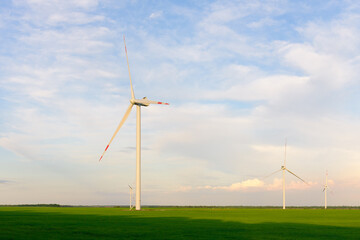 View on alternative energy windmills in a windpark in Ulyanovsk in front of a blue sky. Windmills for electric power production.