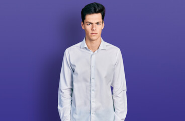 Young hispanic business man wearing business clothes skeptic and nervous, frowning upset because of problem. negative person.