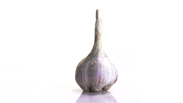 garlic rotates on its axis on a white background