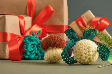 handmade. knitted balls for the Christmas tree, various crocheted Christmas toys, fir branches and gift boxes