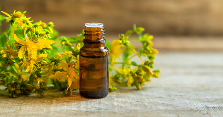 St. John's wort essential oil in a small bottle. Selective focus.
