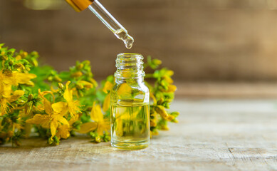 St. John's wort essential oil in a small bottle. Selective focus.