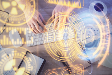 Double exposure of man's hands typing over computer keyboard and tech theme hologram drawing. Top view. Technology concept.