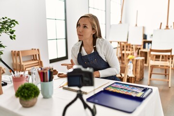 Young caucasian woman recording drawing tutorial at art studio