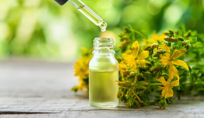 St. John's wort essential oil in a small bottle. Selective focus.