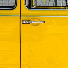 vivid yellow car door and chrome handle, space for your text