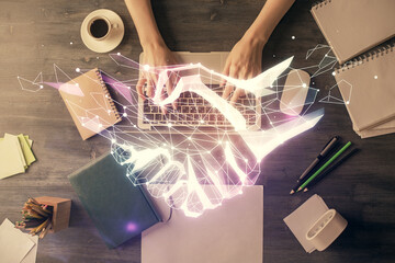 Double exposure of woman hands working on computer and handshake hologram drawing. Top View....