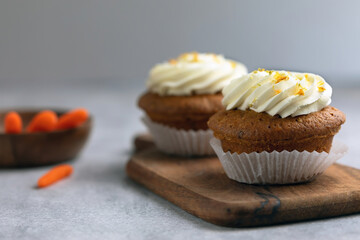carrot cupcake on a wooden board, ingredients on the back