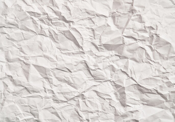 Obraz premium White crumpled paper texture with wrinkles. Damaged and torn sheet