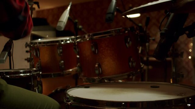 Drummer playing the drums in the studio, close up