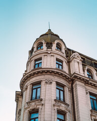 Fototapeta na wymiar Old building from Bucharest with beautiful architecture and balcony, vibrant sky