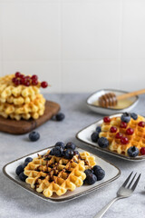 breakfast served - waffles with berries and honey