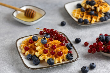 breakfast served - waffles with berries and honey