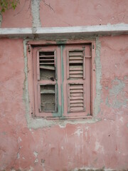 Weathered shutter of a tropical dilapidated building
