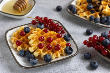 breakfast served - waffles with berries and honey