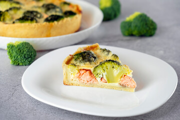 Piece of casserole with broccoli, salmon, soft cheese and omelette in shortcrust pastry. Mediterranean paleo or ketogenic healthy diet. Delicisouc dish for festive cooking.