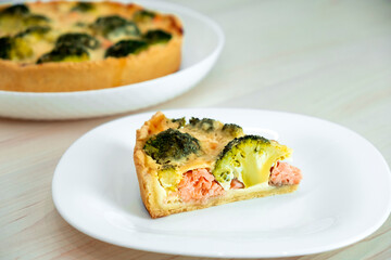 Egg-based frittata, omelette with salmon, broccoli and cheese in crust. Mediterranean paleo or ketogenic healthy diet. Delicisouc dish for restaurant or cafe menu.