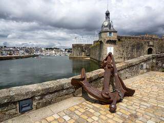 View on an old anchor with the fortress of Concarneau in background