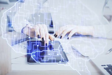 Double exposure of brain sketch hologram and woman holding and using a mobile device.
