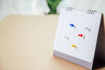 Calendar desk place on the table. Desktop Calender for Planner to plan agenda, timetable, appointment, organization, management each date, month, and year on wooden office table. Calendar Concept.