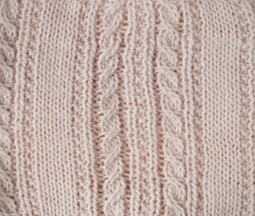Texture de tricot en laine rose pâle avec côtes