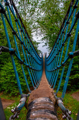 Rope bridge in Aqua magica park in Bad Oeynhausen. Empty walkway through the nature. Germany