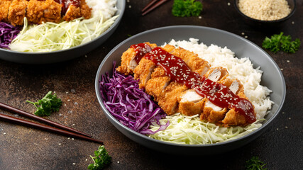 Crispy Katsu chicken with sauce, rice and cabbage.