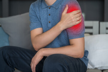 Fototapeta premium Man with pain in shoulder at home