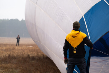 Man preparing a partially inflated hot air balloon