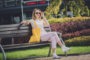 Young beautiful woman with linen eco bag on city background.