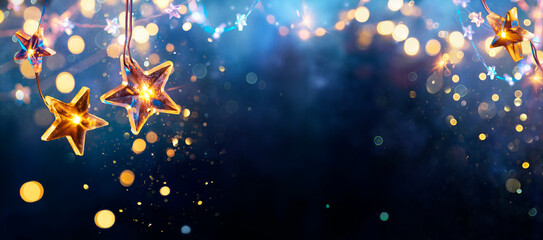 Christmas Stars Lights - Golden String Hanging In Blue Background With Abstract Defocused Bokeh